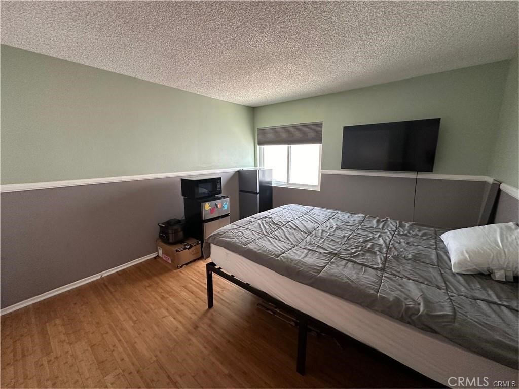 15980 Filbert Street Sylmar, CA 91342 - Photo 12 of 17 a bedroom with a bed and a flat screen tv