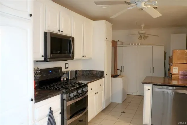 a kitchen with stainless steel appliances a stove microwave and refrigerator