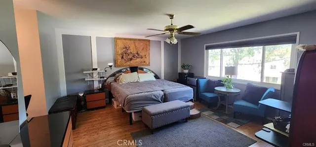 a bedroom with furniture and a large window