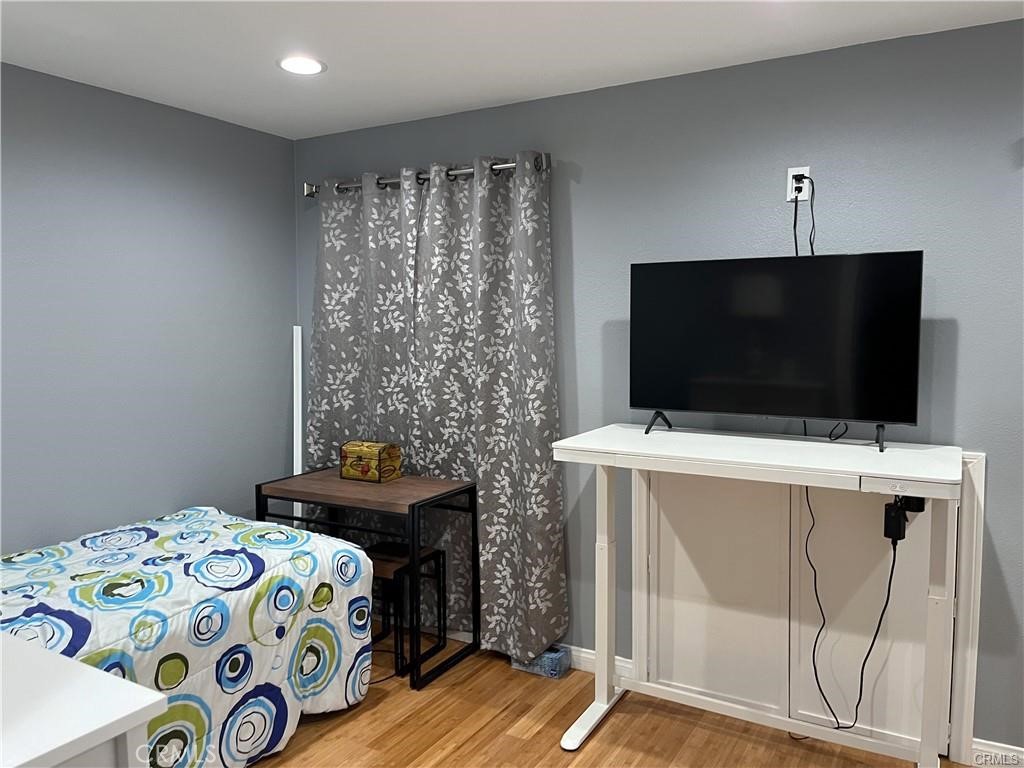 15980 Filbert Street Sylmar, CA 91342 - Photo 10 of 17 a bedroom with a bed and a flat screen tv