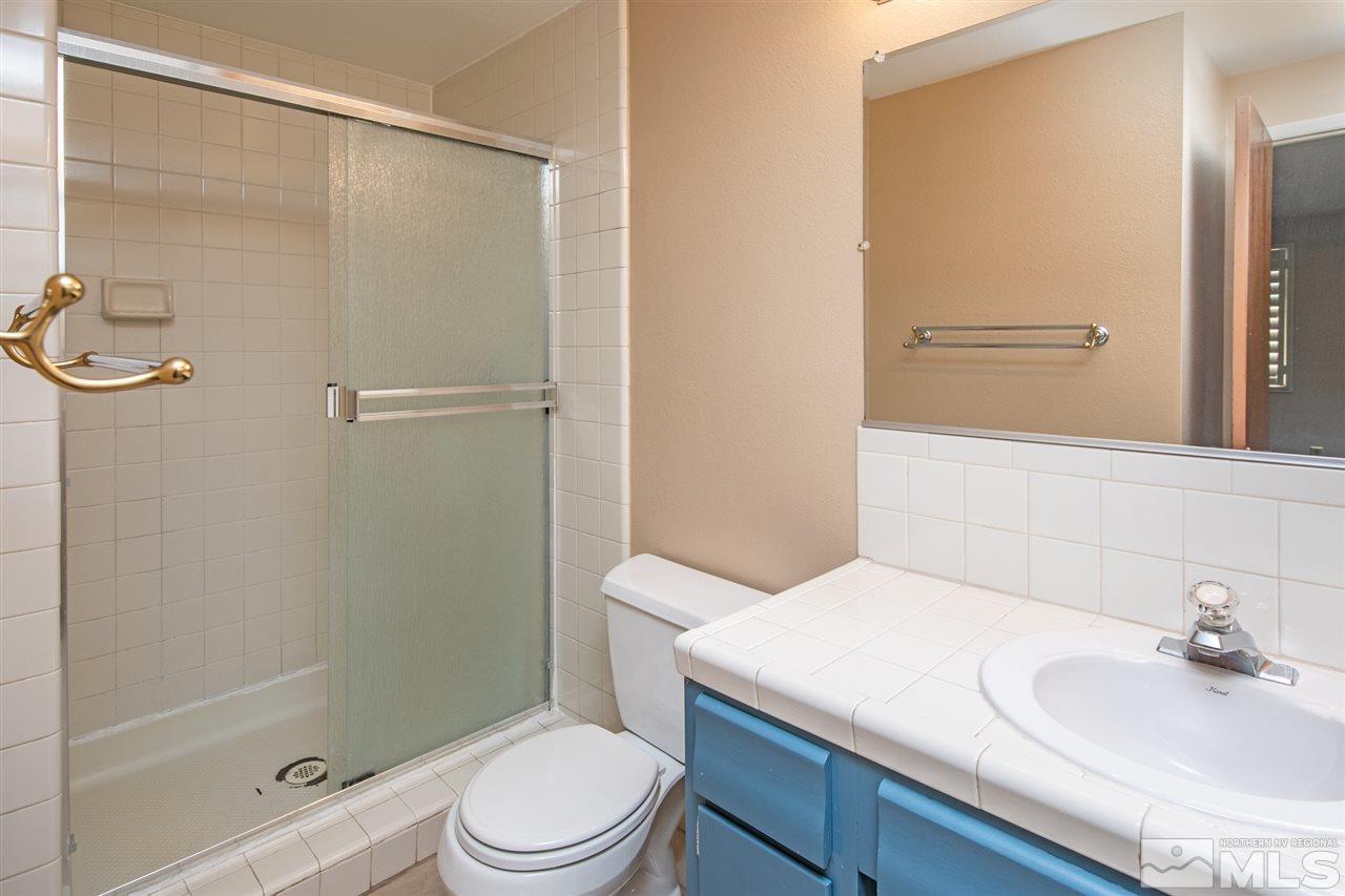 4095 Warren Way Reno, NV 89509 - Photo 12 of 17 a bathroom with a sink a toilet and shower