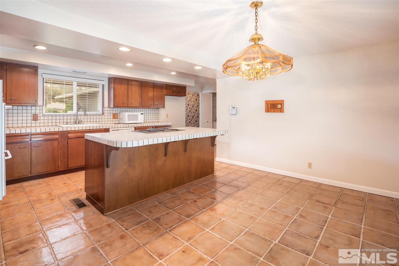 4095 Warren Way Reno, NV 89509 - Photo 6 of 17 a kitchen with stainless steel appliances a sink a stove a microwave a counter top space and cabinets