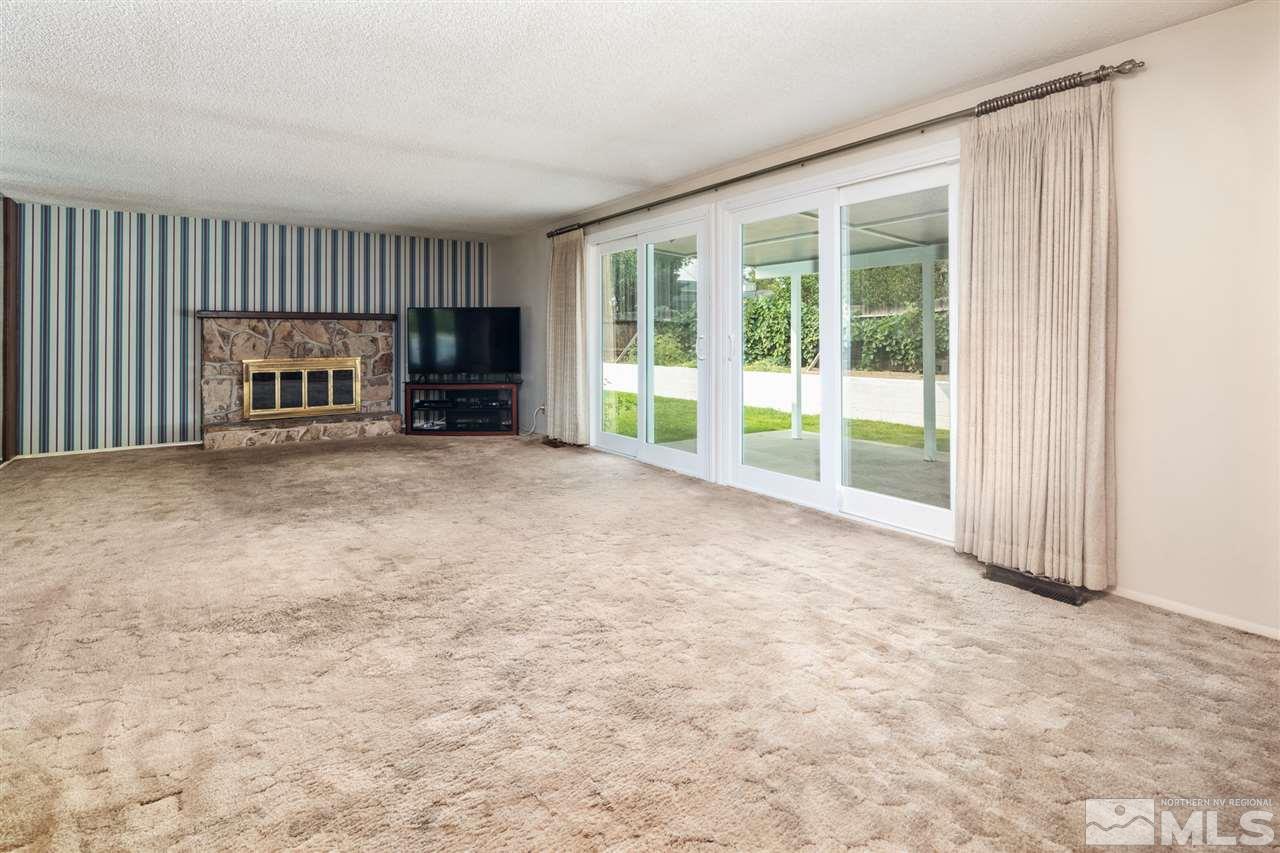 4095 Warren Way Reno, NV 89509 - Photo 8 of 17 a view of an empty room with a fireplace and a window