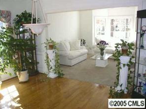 9102 Laurel Ridge Trail Charlotte, NC 28269 - Photo 5 of 8 a living room with furniture a potted plant and a large window