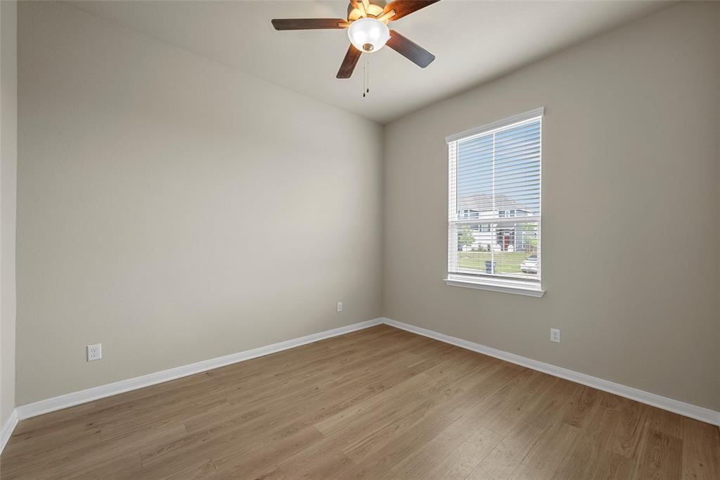 3205 Dottavio Road Lorena, TX 76655 - Photo 25 of 33 Room featuring wood-finish flooring, neutral wall paint, and white baseboards