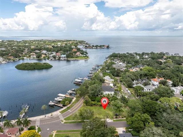 an aerial view of residential house with outdoor space and lake view in back