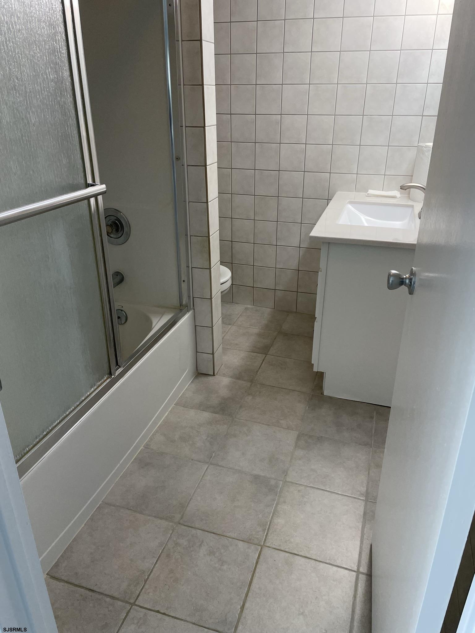 61 Simpson Road, Unit 2 Ocean City, NJ 08226 - Photo 15 of 16 a bathroom with a sink a toilet and shower