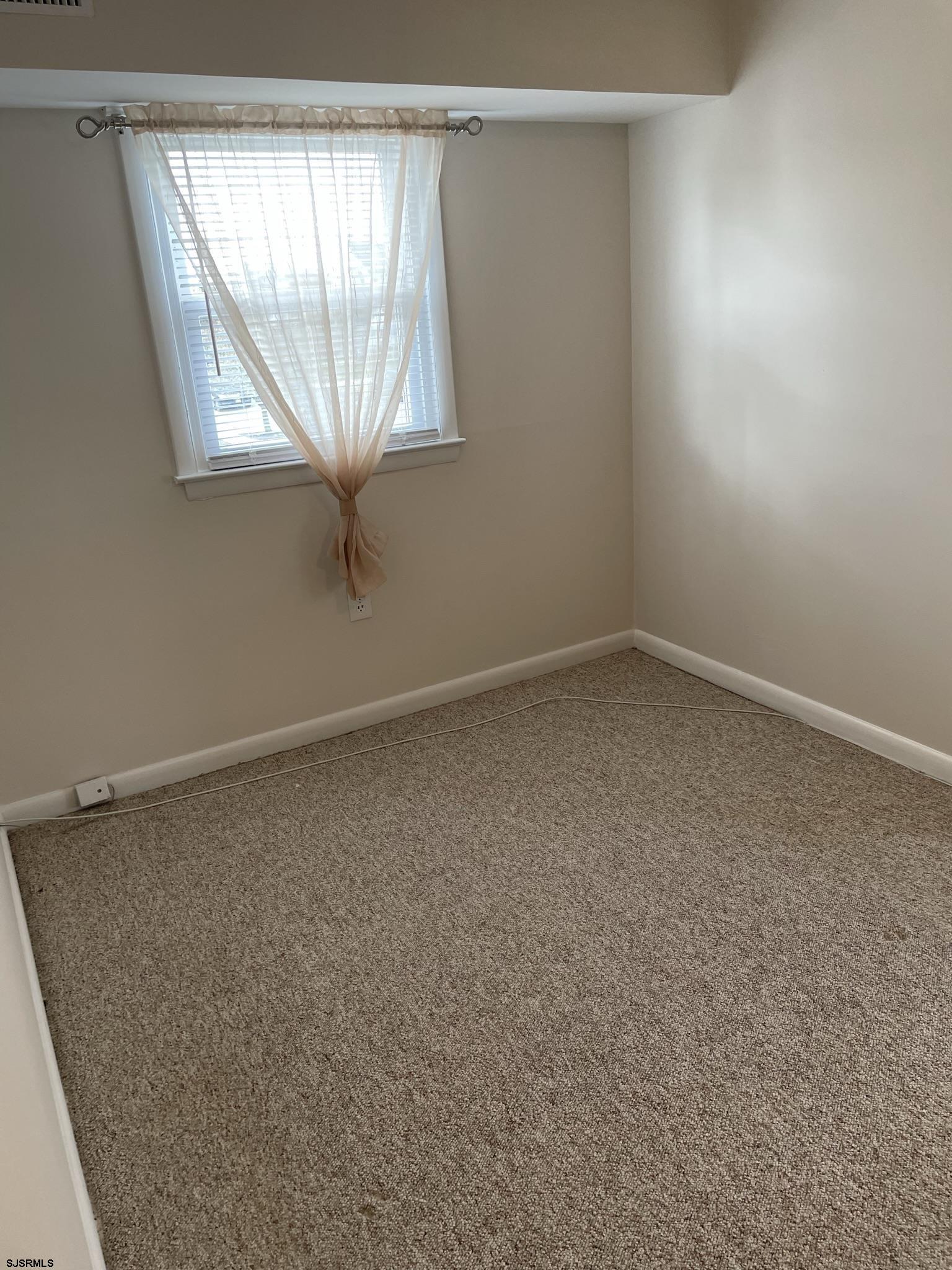 61 Simpson Road, Unit 2 Ocean City, NJ 08226 - Photo 6 of 16 an empty room with a window