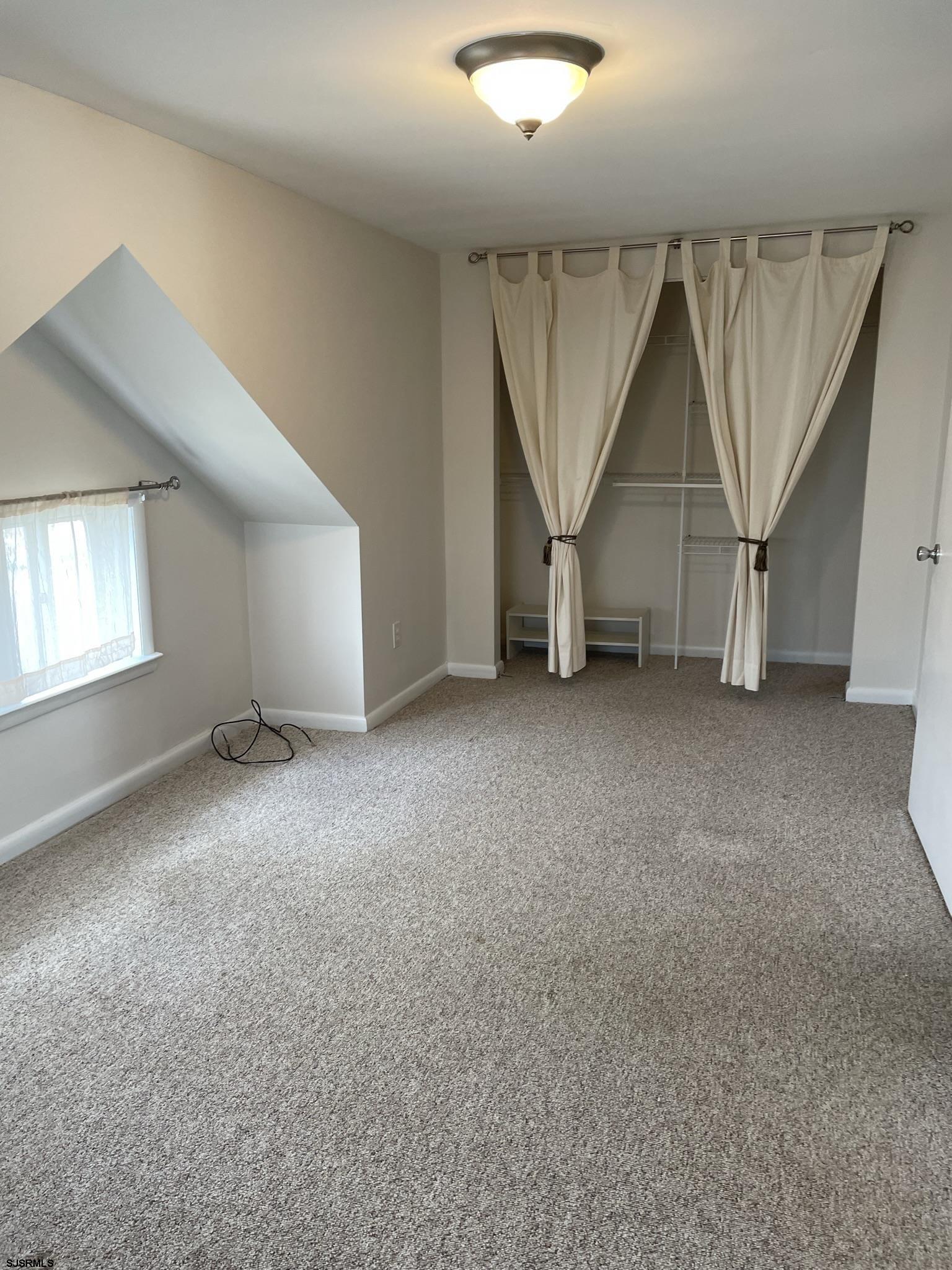 61 Simpson Road, Unit 2 Ocean City, NJ 08226 - Photo 7 of 16 an empty room with windows