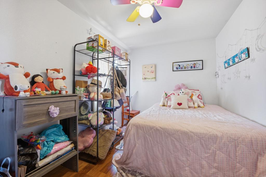 2077 Westwood Road Vista, CA 92083 - Photo 24 of 37 a bedroom with a bed and a chandelier