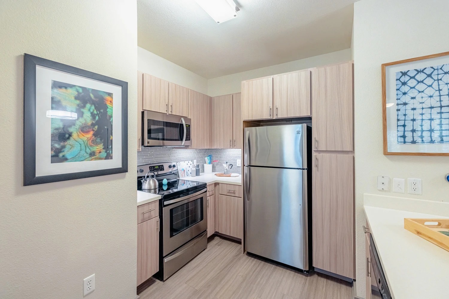 8515 Interstate 35, Unit 9106 Austin, TX 78744 - Photo 14 of 24 a kitchen with stainless steel appliances a refrigerator a stove a microwave and cabinets