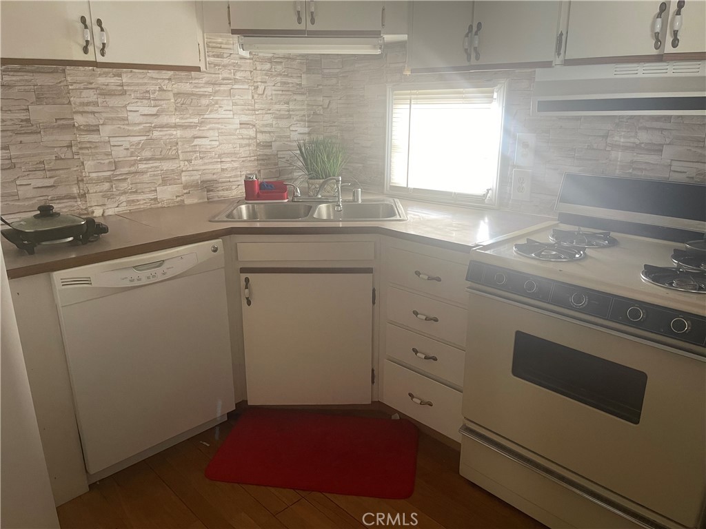 69510 Parkside Drive Desert Hot Springs, CA 92241 - Photo 5 of 5 a kitchen with a sink stove and cabinets