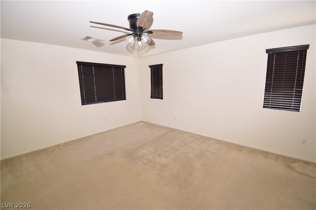 3622 Via Terracina Henderson, NV 89052 - Photo 14 of 22 A well-lit bedroom offering a blank canvas for personalization, complete with a ceiling fan for comfort.