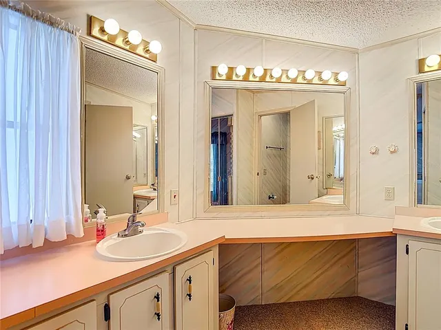 a bathroom with a sink double vanity and a mirror