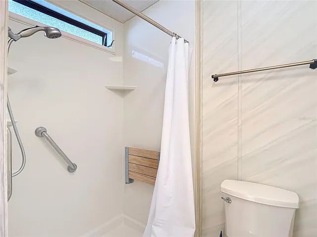 a bathroom with a shower and a toilet