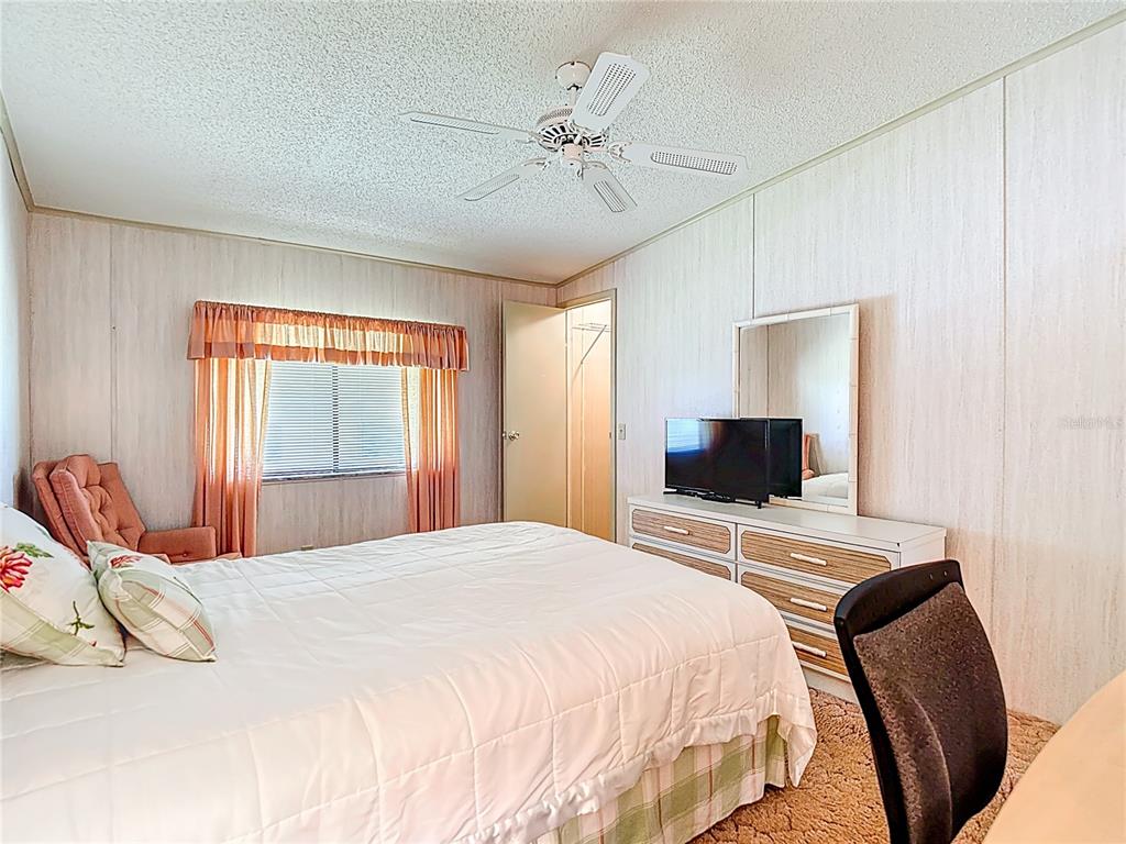 14761 Rialto Avenue Brooksville, FL 34613 - Photo 13 of 23 a bedroom with a bed and a flat screen tv