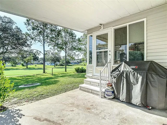 a view of a house with backyard and patio