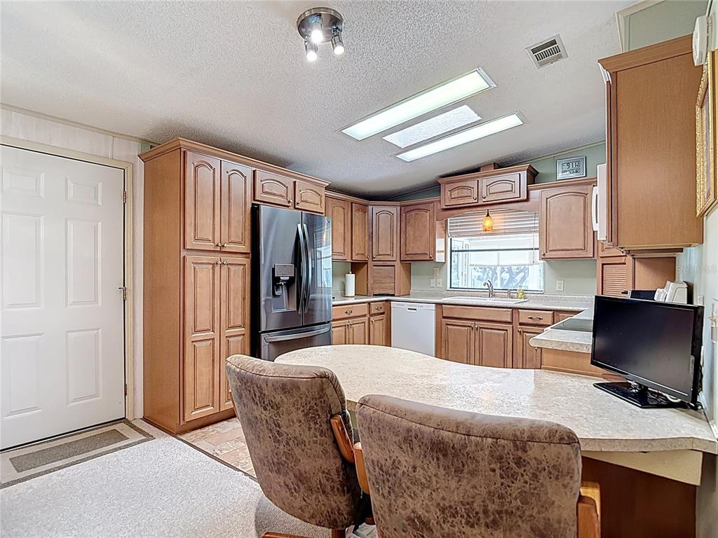 14761 Rialto Avenue Brooksville, FL 34613 - Photo 2 of 23 a kitchen with stainless steel appliances granite countertop a refrigerator and a stove top oven