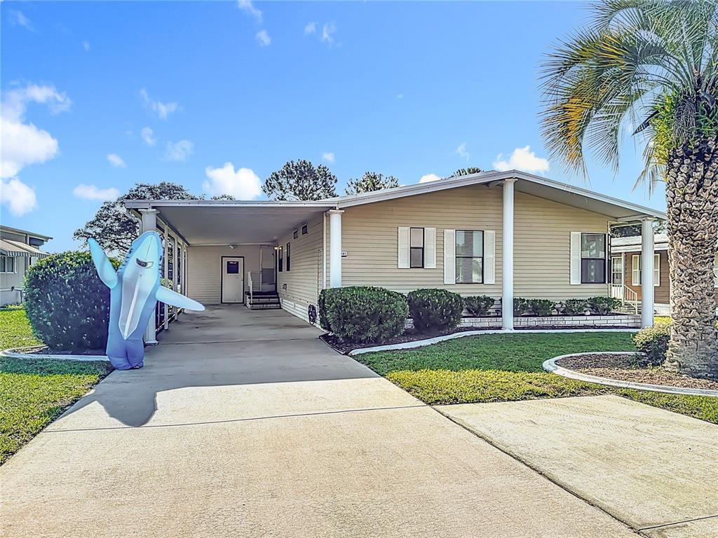14761 Rialto Avenue Brooksville, FL 34613 - Photo 23 of 23 a front view of a house with a yard and potted plants