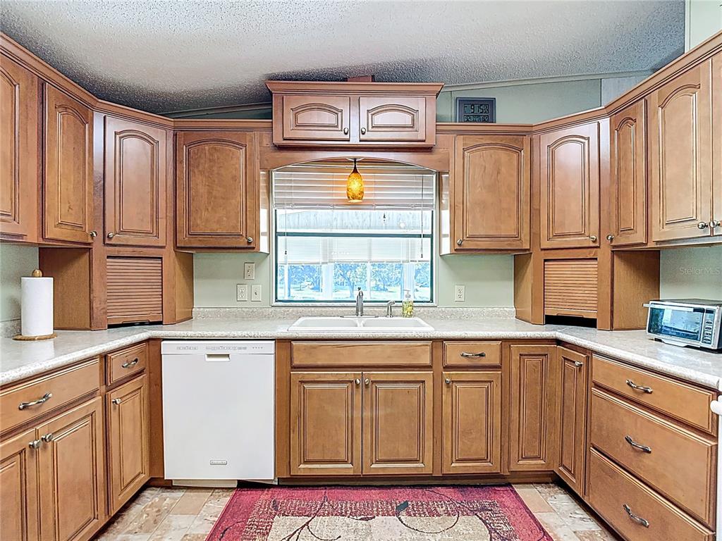 14761 Rialto Avenue Brooksville, FL 34613 - Photo 3 of 23 a kitchen with stainless steel appliances granite countertop a sink and cabinets