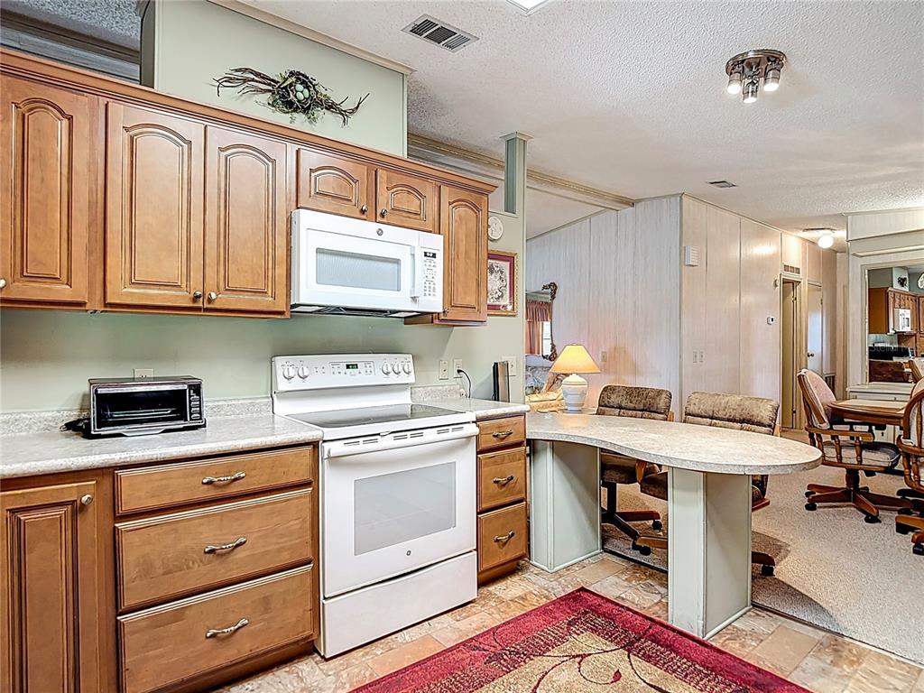 14761 Rialto Avenue Brooksville, FL 34613 - Photo 4 of 23 a kitchen with a stove a sink and cabinets