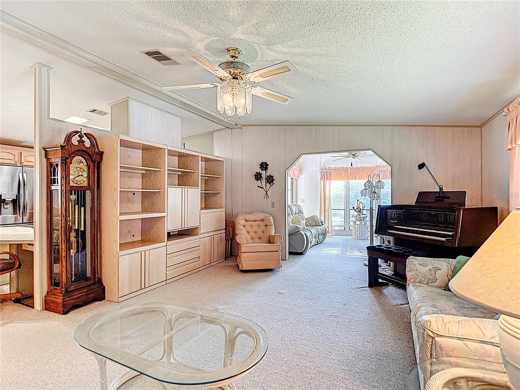 14761 Rialto Avenue Brooksville, FL 34613 - Photo 6 of 23 a living room with furniture and a chandelier