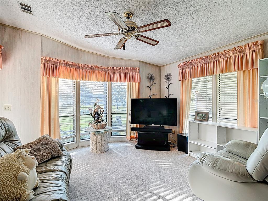 14761 Rialto Avenue Brooksville, FL 34613 - Photo 7 of 23 a living room with furniture and a flat screen tv