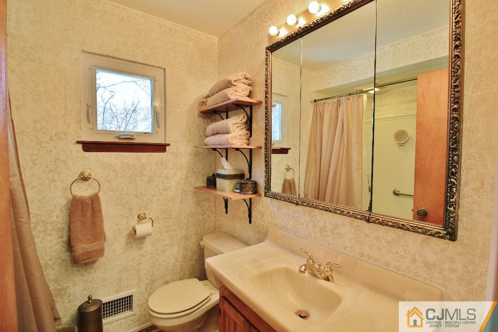 197 North Hill Road Colonia, NJ 07067 - Photo 22 of 25 a bathroom with a sink a toilet and shower