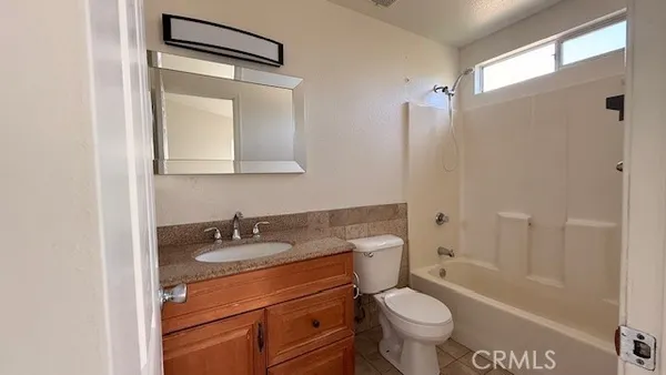 a bathroom with a sink toilet vanity and shower