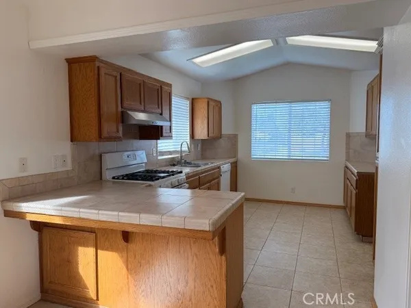 a kitchen with a sink cabinets and a window