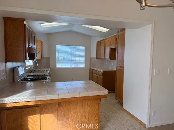 a kitchen with a stove and a refrigerator