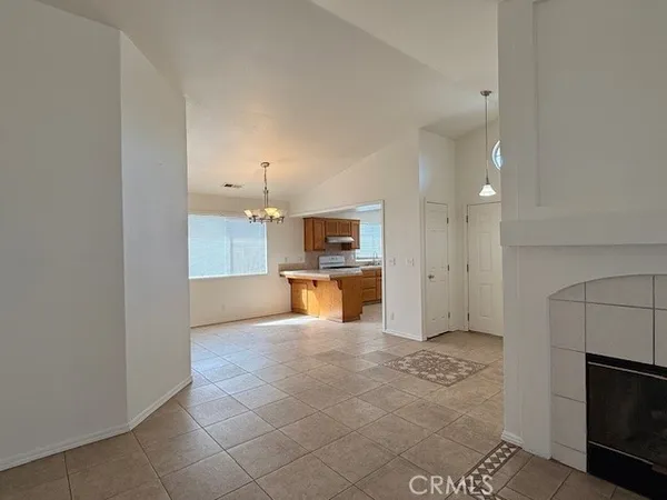 a view of a kitchen with a refrigerator and a sink