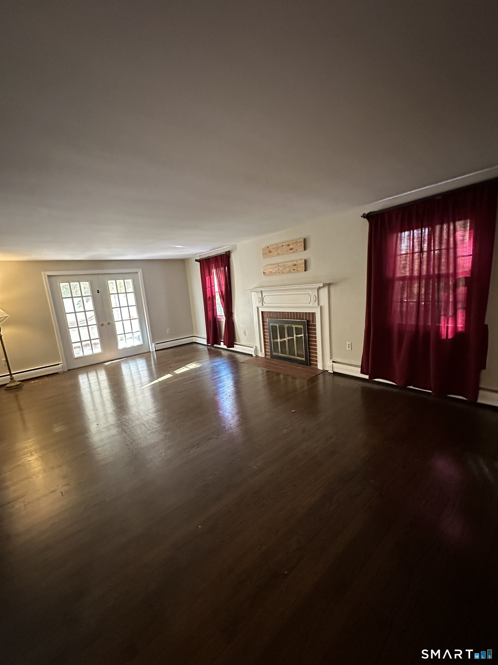 26 South Glenwoods Road Ledyard, CT 06335 - Photo 6 of 12 a view of empty room with wooden floor and fan