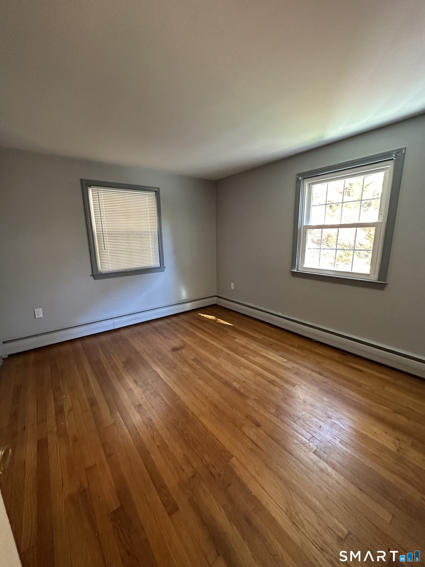 26 South Glenwoods Road Ledyard, CT 06335 - Photo 7 of 12 wooden floor in an empty room with a window
