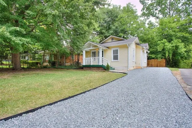 a view of a house with a backyard