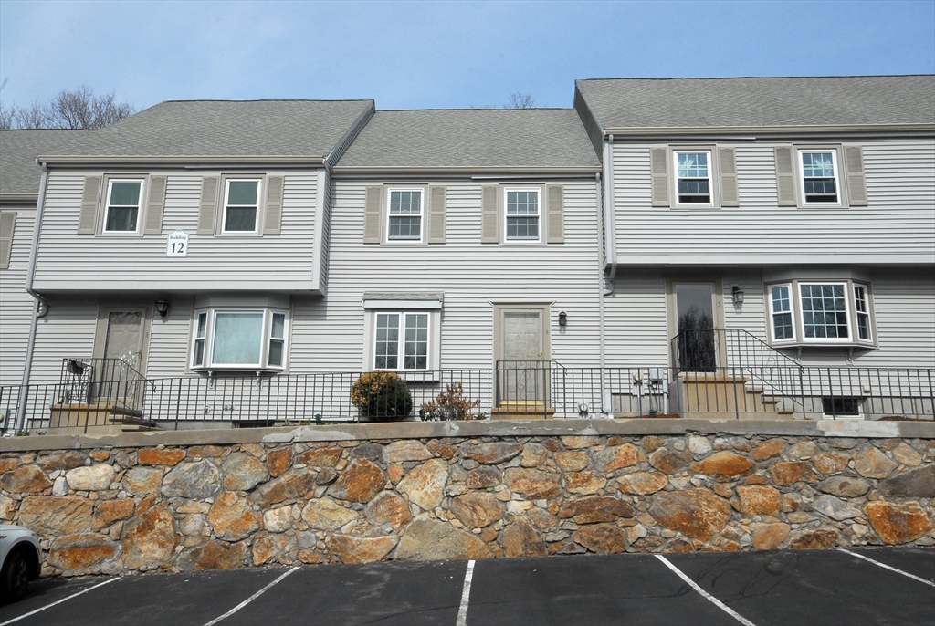 12 Oak Ridge Drive, Unit 4 Maynard, MA 01754 - Photo 1 of 36 a front view of a house with a yard