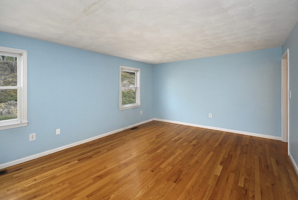 12 Oak Ridge Drive, Unit 4 Maynard, MA 01754 - Photo 13 of 36 a view of an empty room with wooden floor and a window