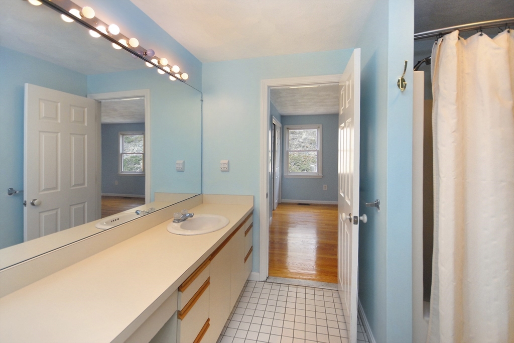 12 Oak Ridge Drive, Unit 4 Maynard, MA 01754 - Photo 15 of 36 a bathroom with a sink and a mirror