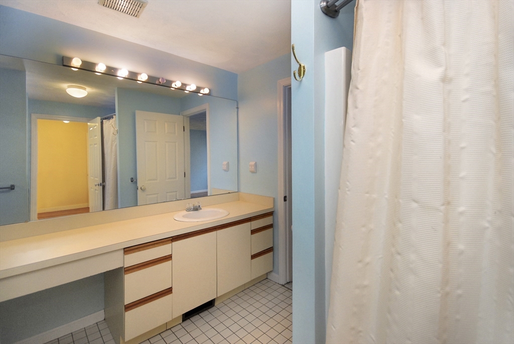 12 Oak Ridge Drive, Unit 4 Maynard, MA 01754 - Photo 16 of 36 a bathroom with a double vanity sink and a mirror