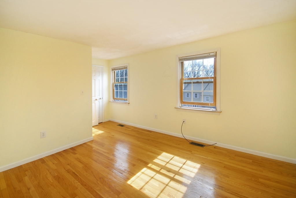 12 Oak Ridge Drive, Unit 4 Maynard, MA 01754 - Photo 18 of 36 a view of an empty room with wooden floor and a window