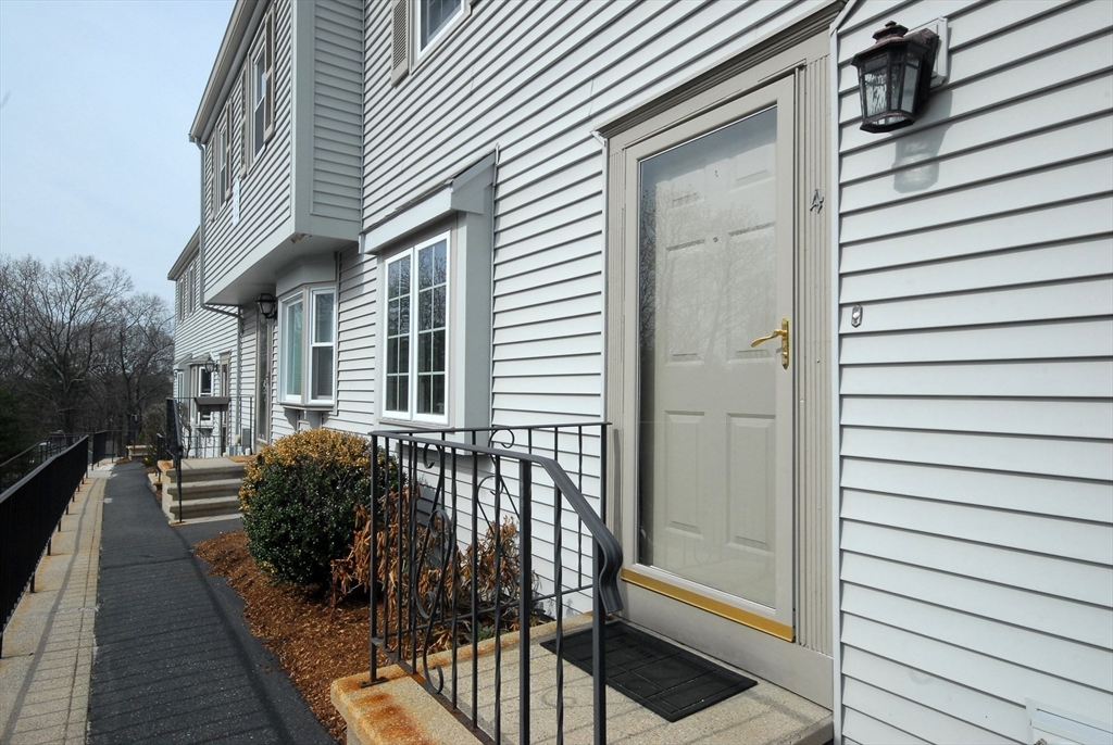 12 Oak Ridge Drive, Unit 4 Maynard, MA 01754 - Photo 2 of 36 a view of a house with a patio
