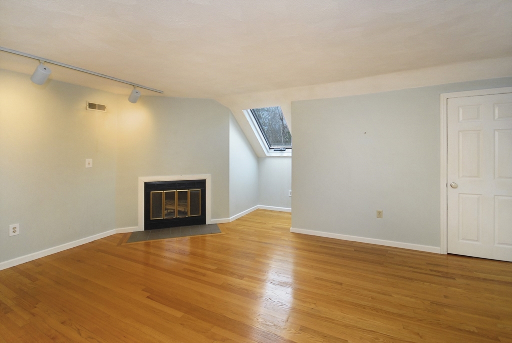 12 Oak Ridge Drive, Unit 4 Maynard, MA 01754 - Photo 22 of 36 a view of an empty room with wooden floor