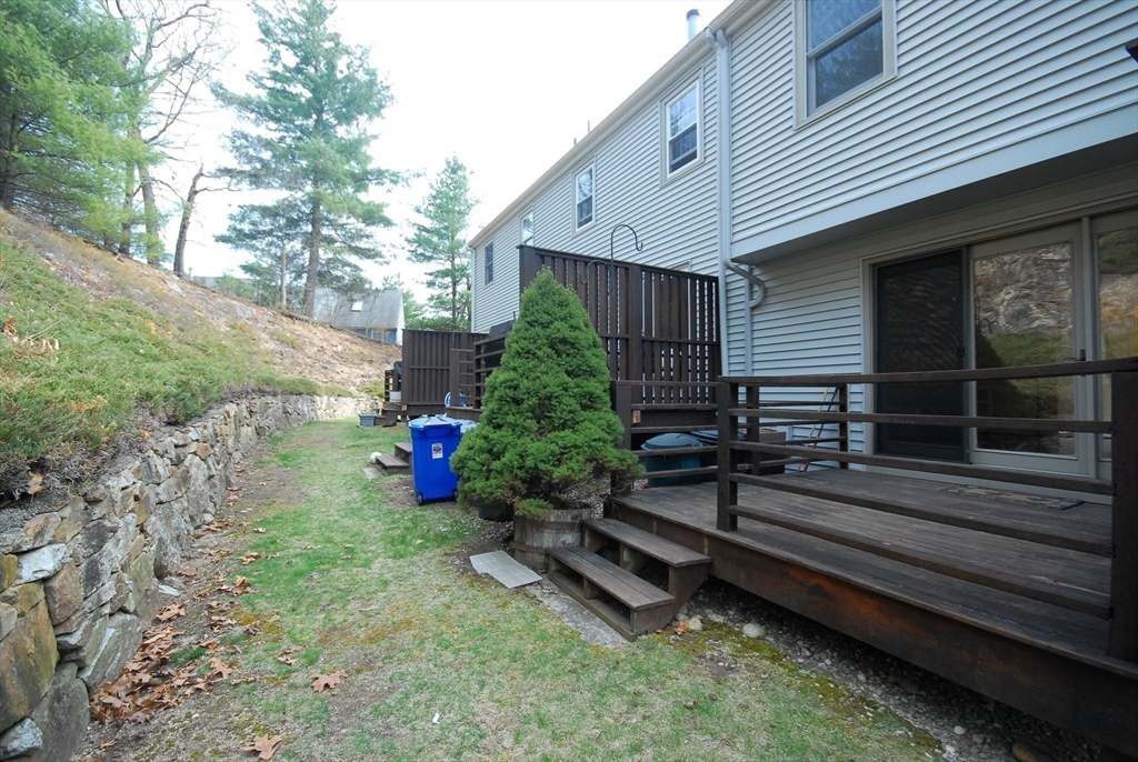 12 Oak Ridge Drive, Unit 4 Maynard, MA 01754 - Photo 30 of 36 a backyard of a house with wooden floor and outdoor seating