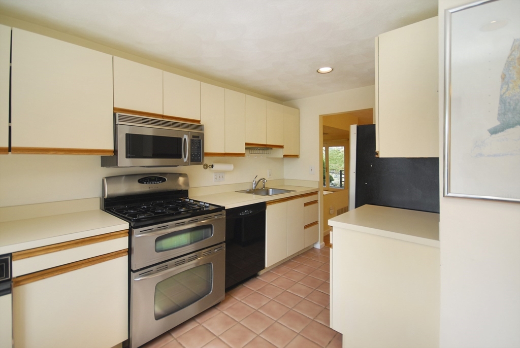 12 Oak Ridge Drive, Unit 4 Maynard, MA 01754 - Photo 5 of 36 a kitchen with a sink a stove top oven and white kitchen