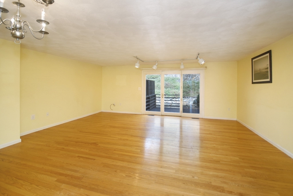12 Oak Ridge Drive, Unit 4 Maynard, MA 01754 - Photo 8 of 36 a view of empty room with wooden floor and fan