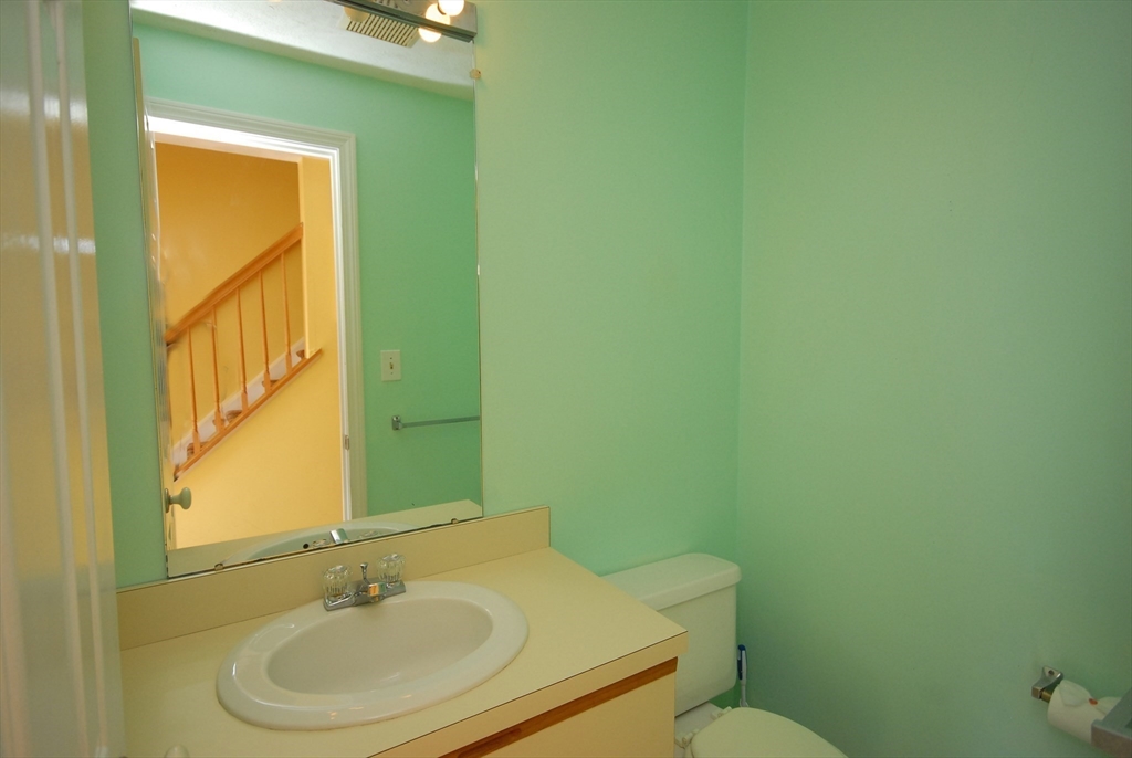12 Oak Ridge Drive, Unit 4 Maynard, MA 01754 - Photo 10 of 36 a bathroom with a sink and a mirror