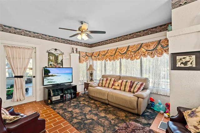 a kitchen with stainless steel appliances granite countertop a stove refrigerator dining table and chairs