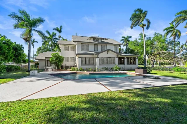 a view of a house with backyard sitting area and garden