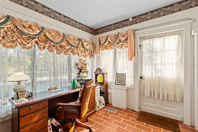 a kitchen with a dining table chairs stainless steel appliances and cabinets