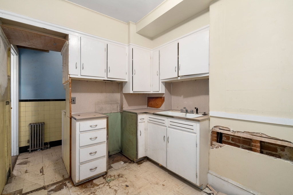 1495 Beacon Street, Unit 3 Brookline, MA 02446 - Photo 12 of 27 a kitchen with cabinets and appliances